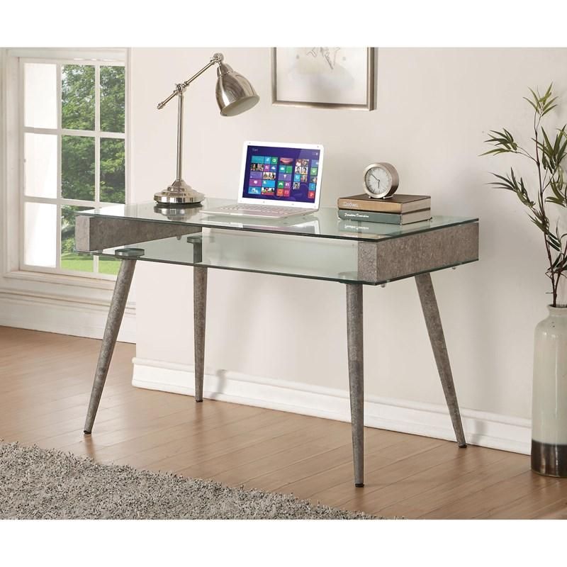 A glass desk with a laptop on it in a living room.