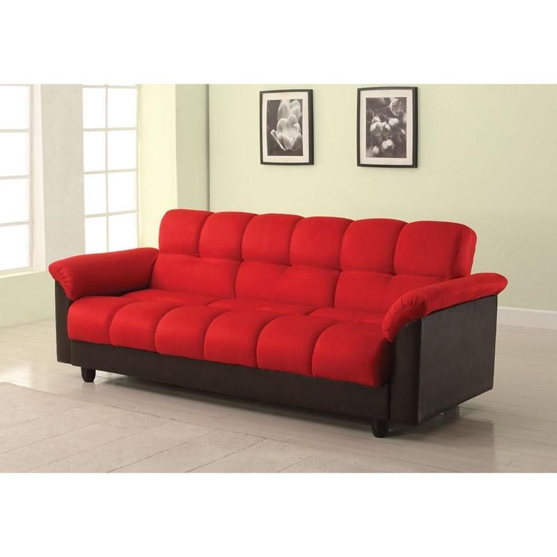 A red couch is in a living room next to two pictures on the wall