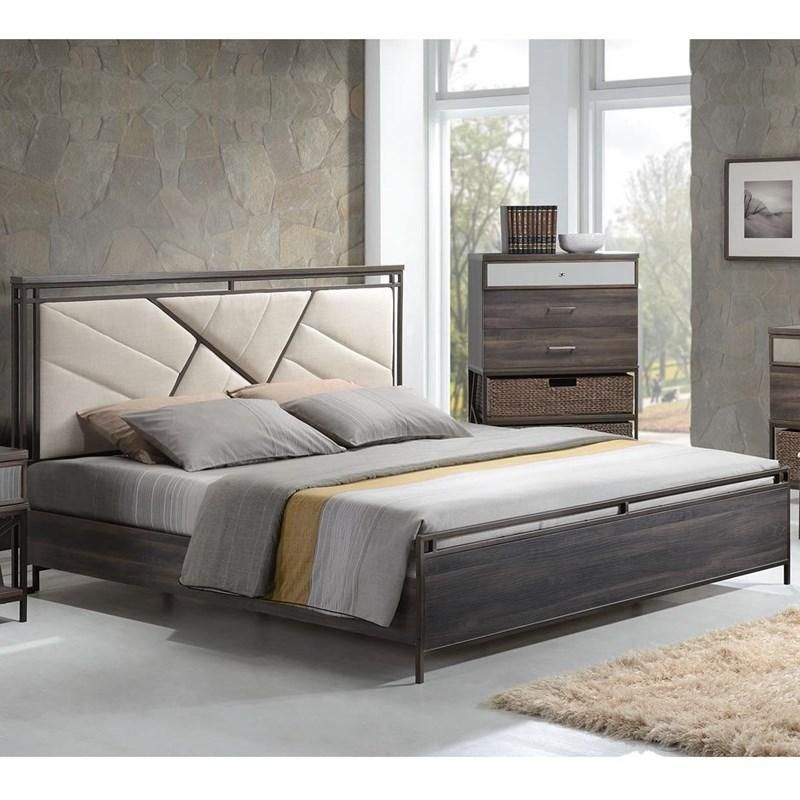 A bedroom with a bed , dresser , nightstand and rug.