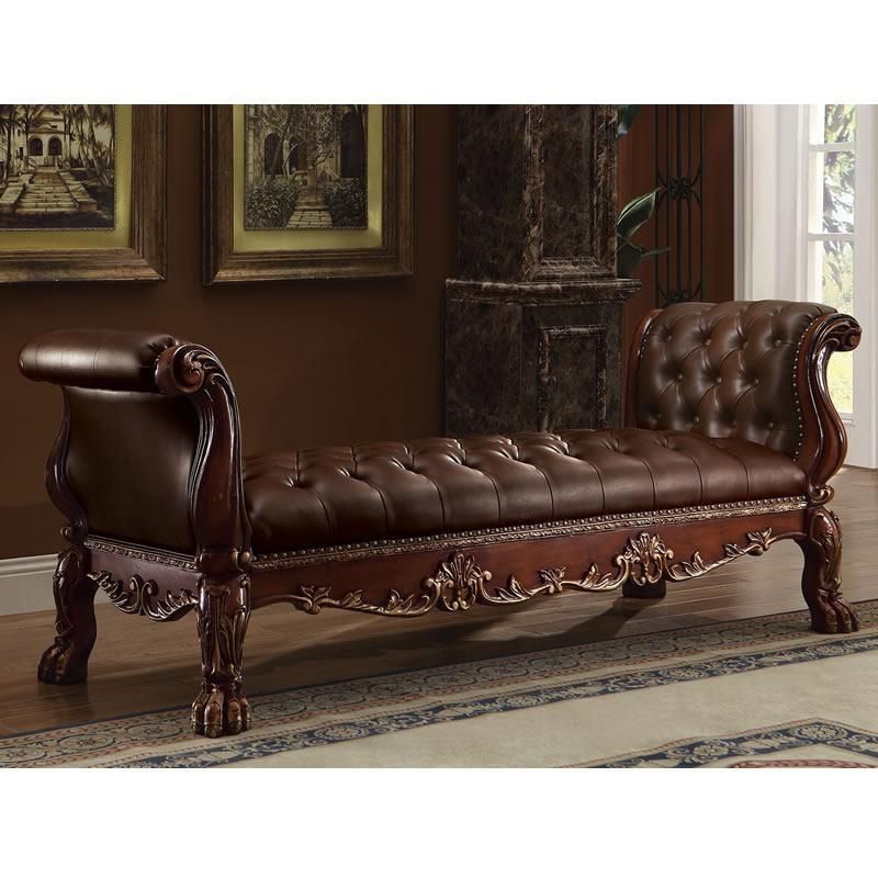 A brown leather bench is sitting in a living room next to a fireplace.