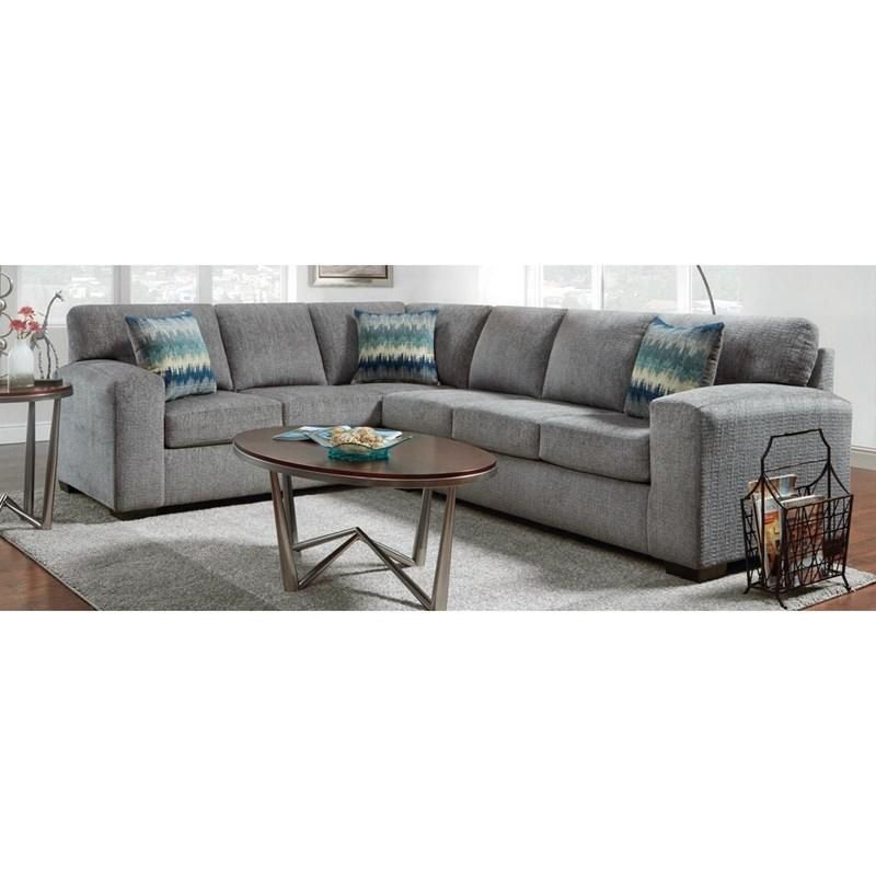 A living room with a gray sectional couch and two coffee tables.