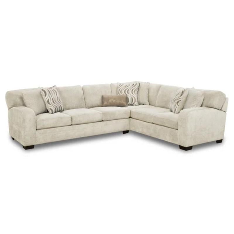 A white sectional couch with pillows on it on a white background.