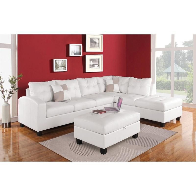 A living room with a white sectional couch and ottoman