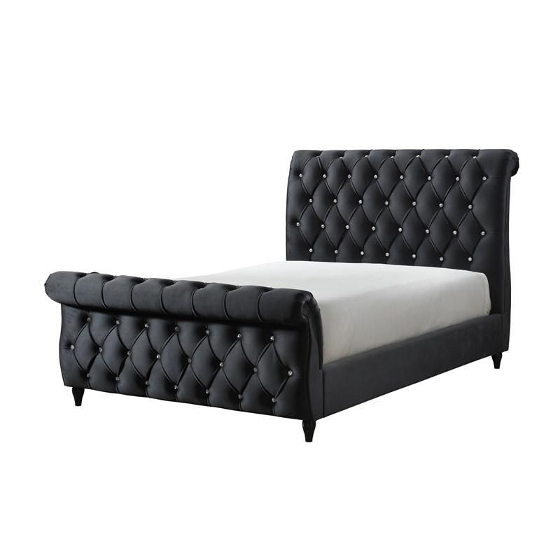 A black tufted bed with a white mattress on a white background
