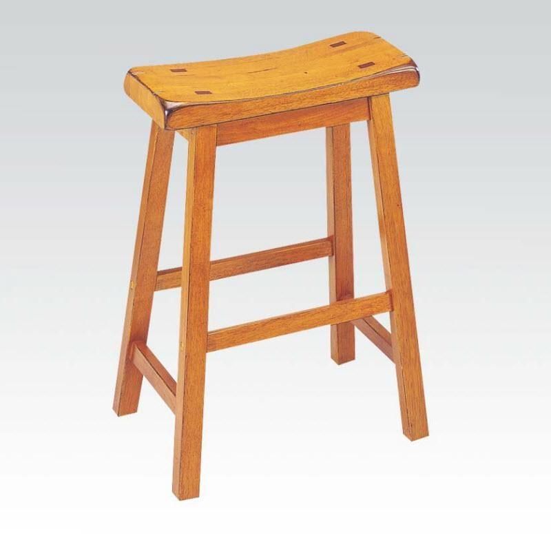A wooden stool is sitting on a white surface