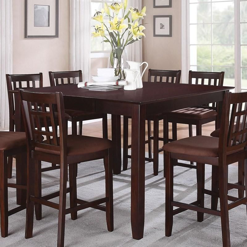 A dining room table with a vase of flowers on it