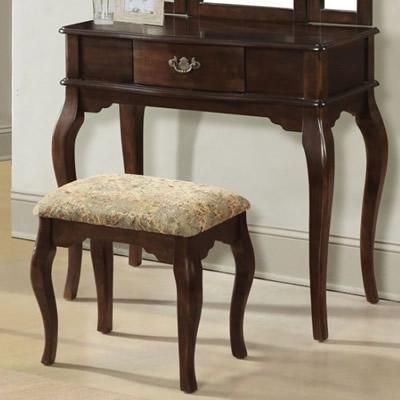 A wooden vanity with a mirror and a stool