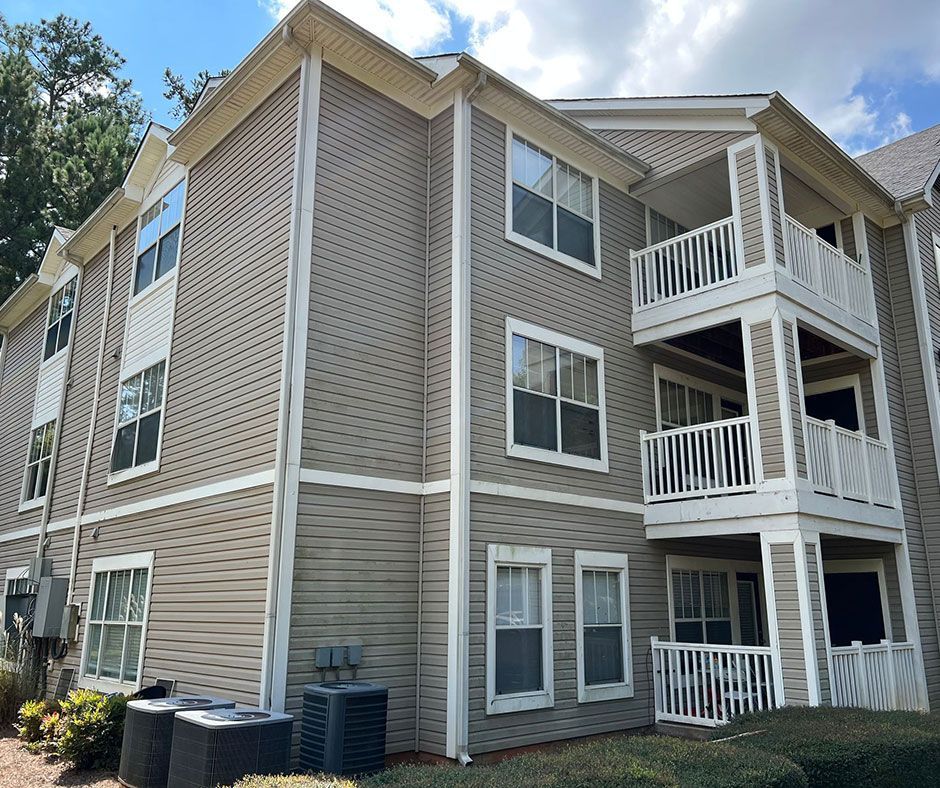 A large apartment building with a lot of windows and balconies