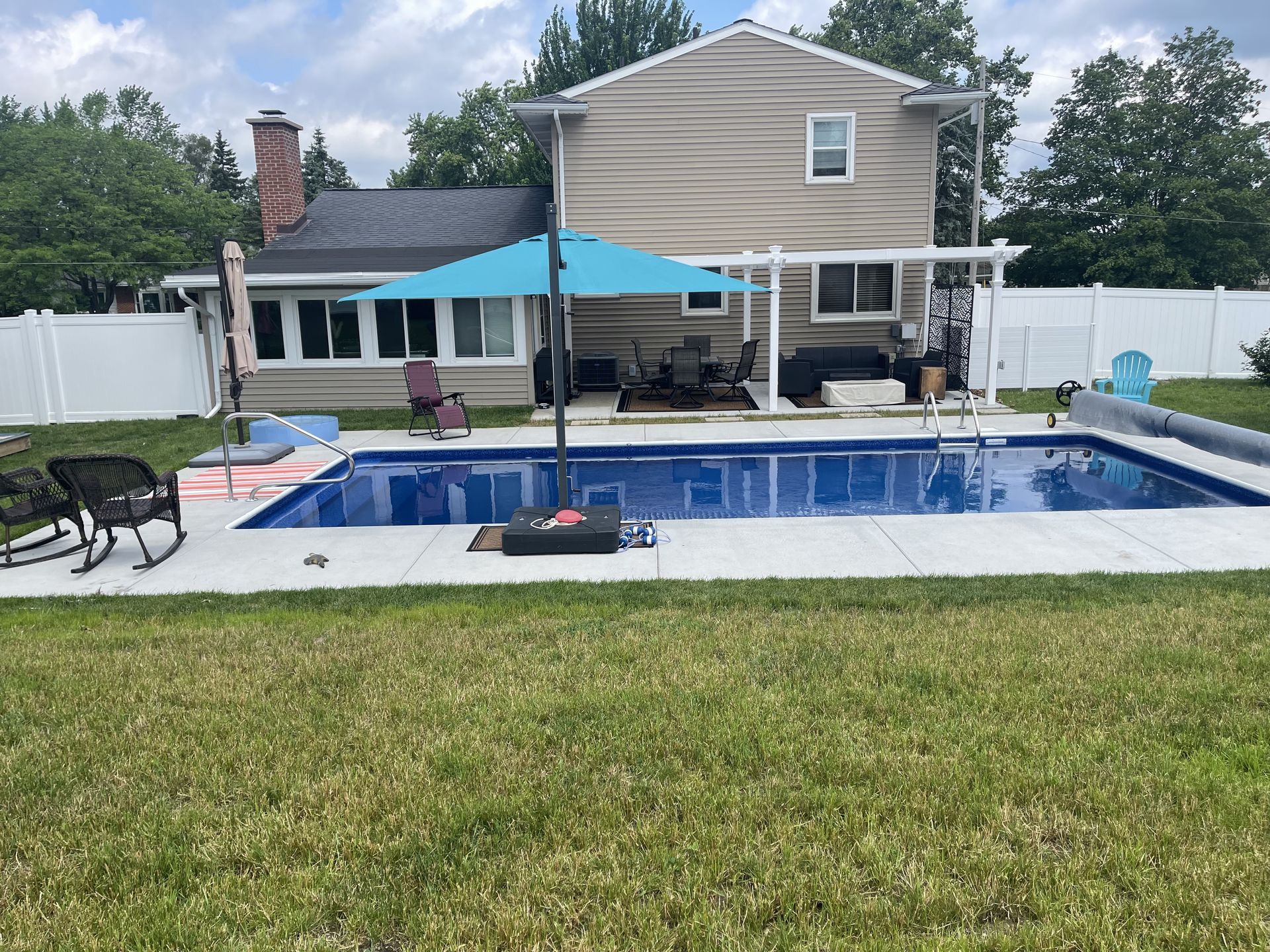 A large swimming pool in the backyard of a house