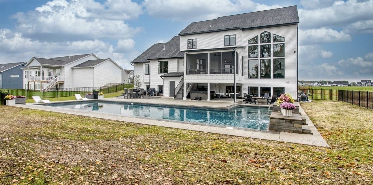 A large house with a large swimming pool in the backyard.