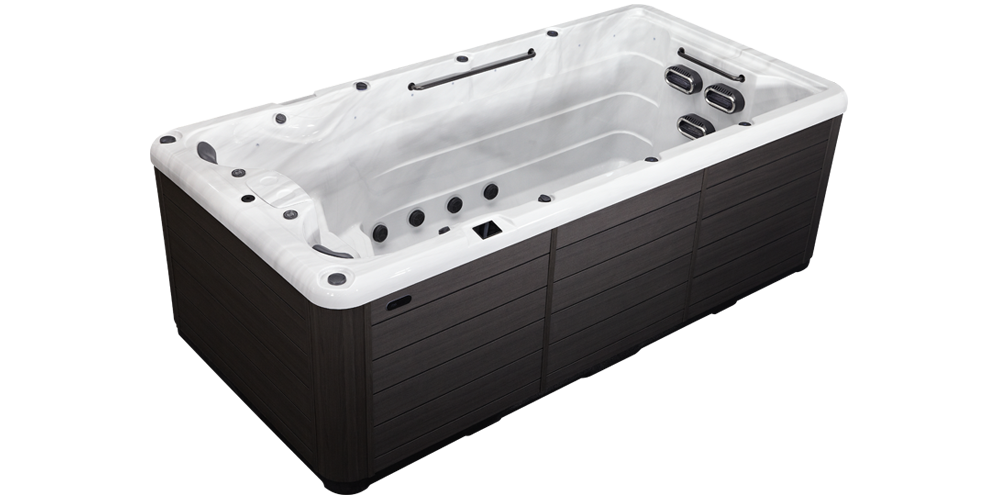A rectangular swim spa with a dark wood-paneled exterior and a white acrylic interior, featuring jets and exercise bars.