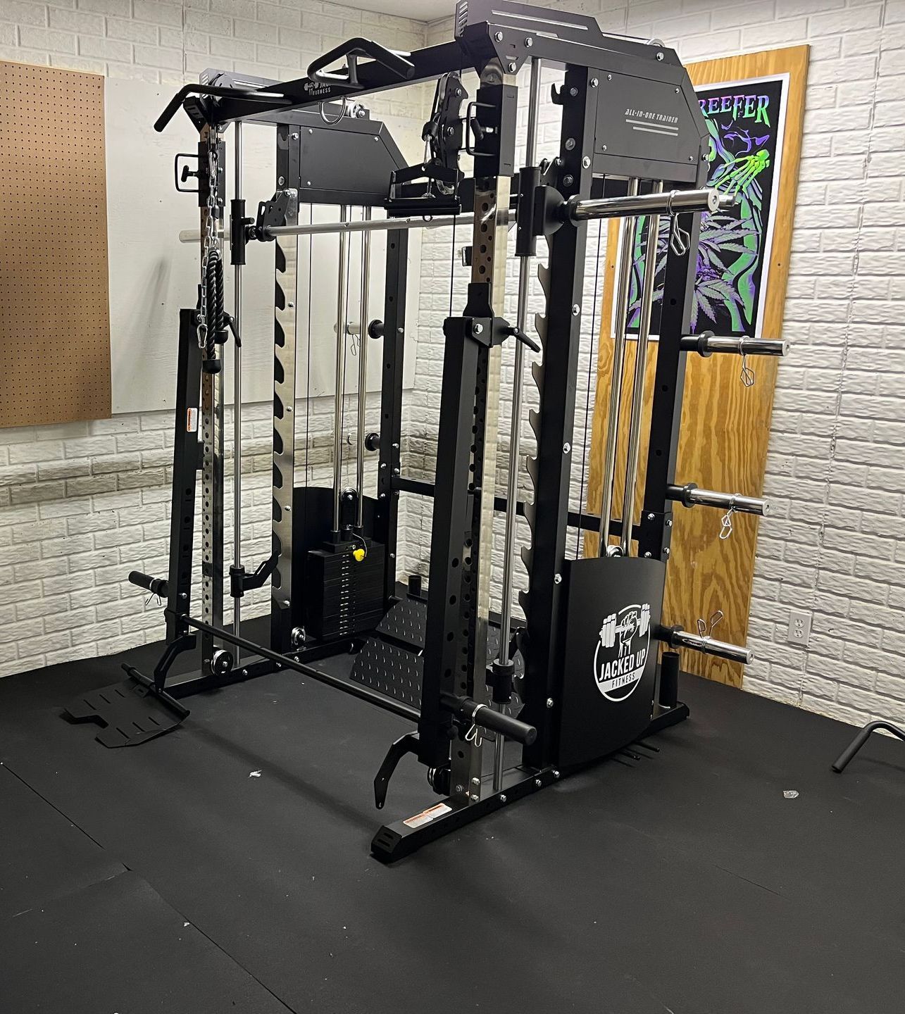 A gym with a lot of equipment and a brick wall.