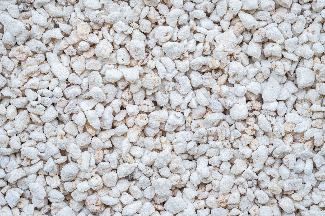 White gravel stones filling the frame, creating a textured rocky surface