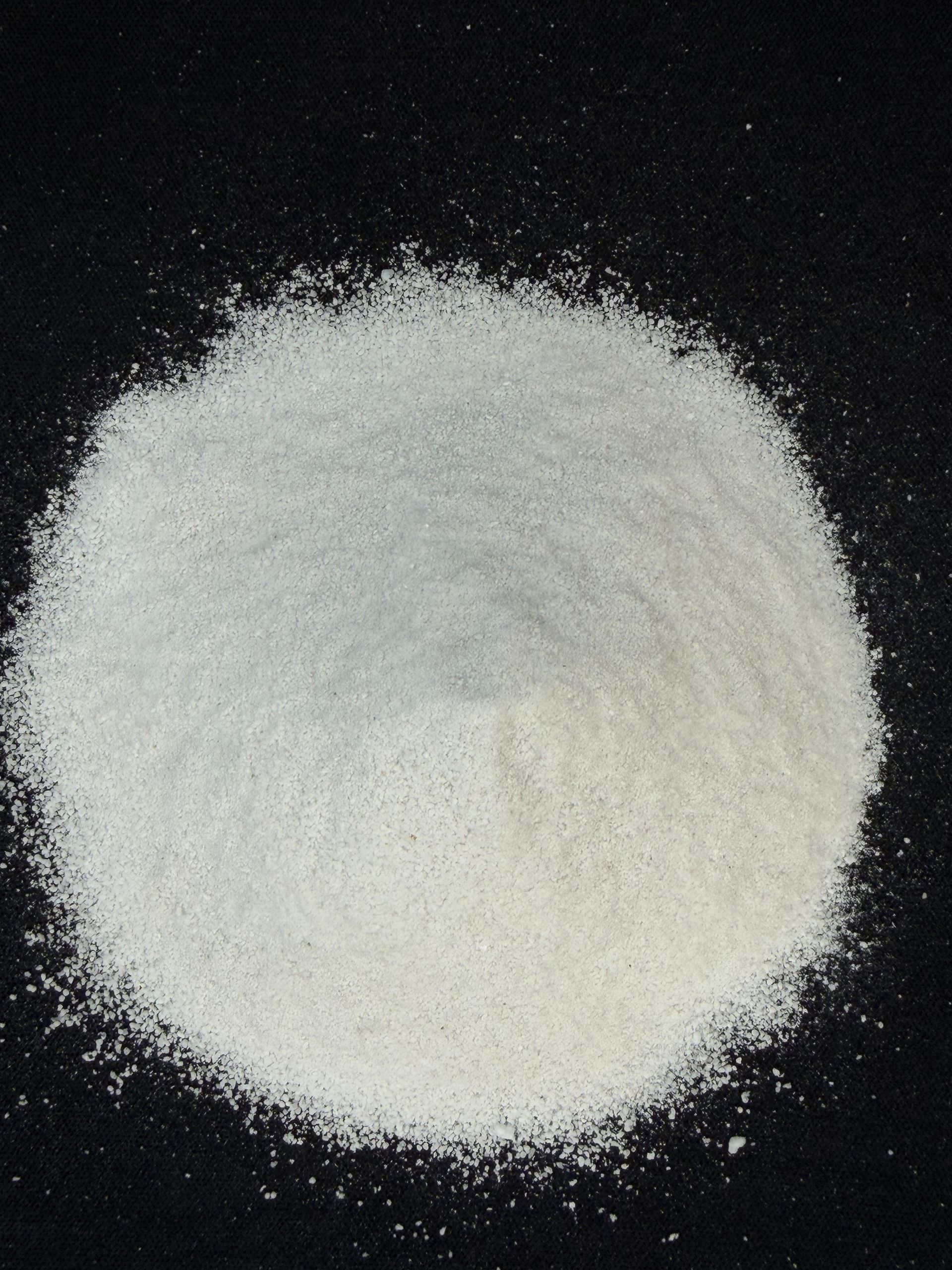 White powder mound on a black background