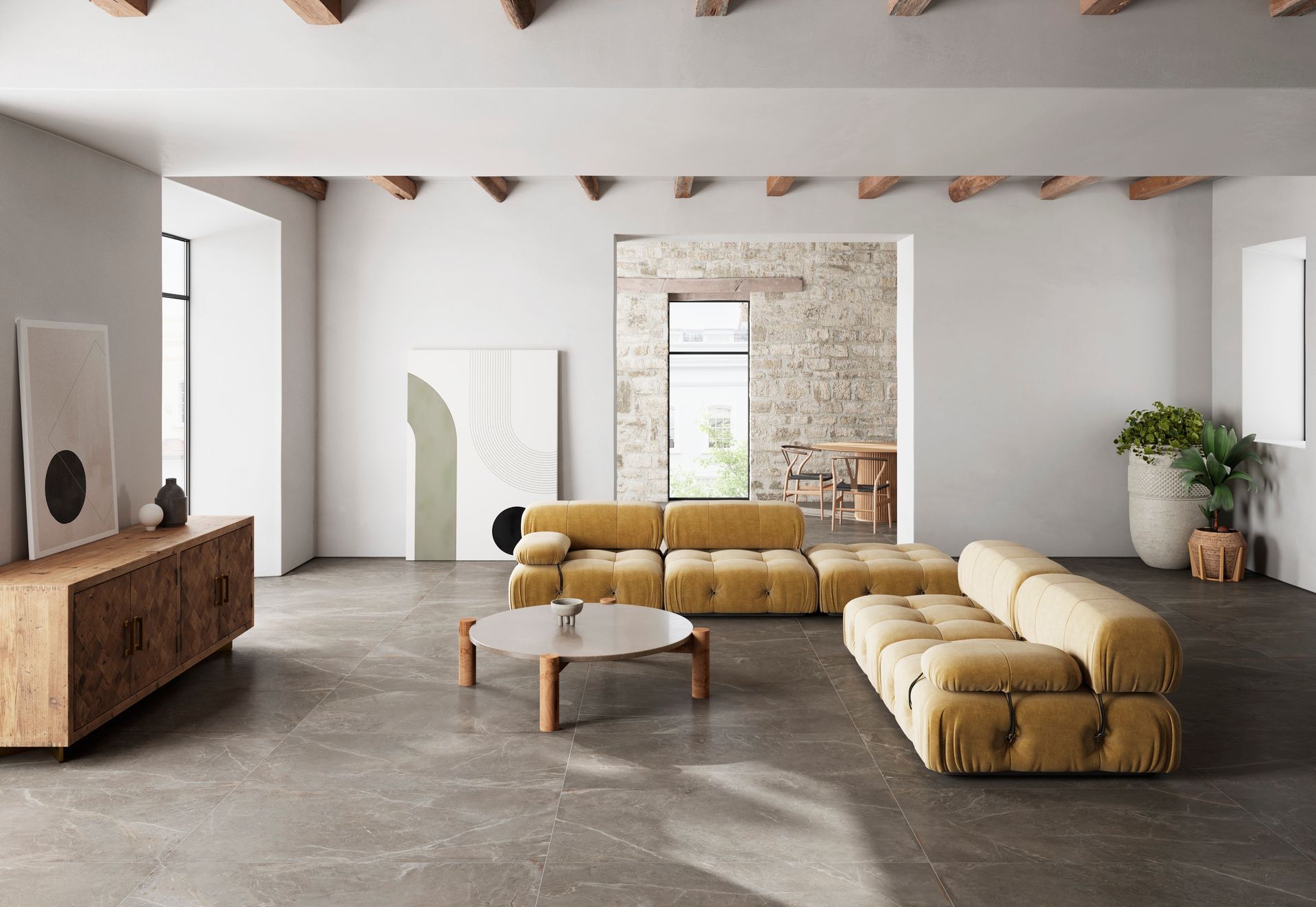A living room with a yellow sectional couch and a coffee table.