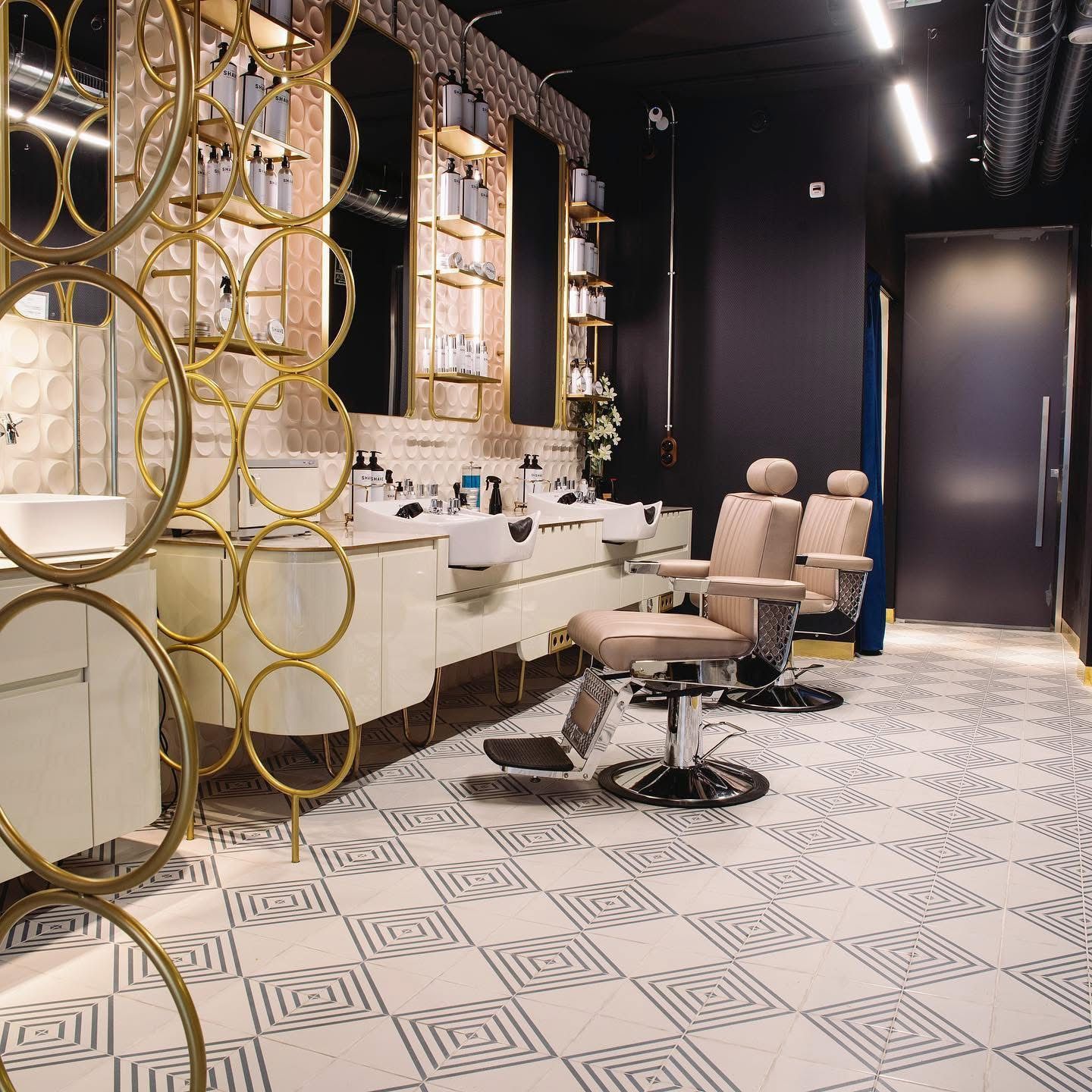 A barber shop with a lot of chairs and sinks.