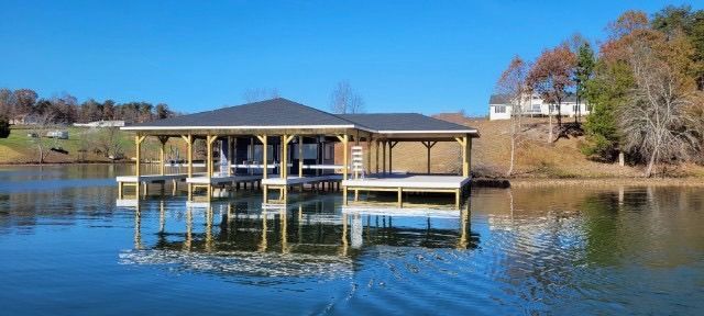 A house is sitting on top of a large body of water.