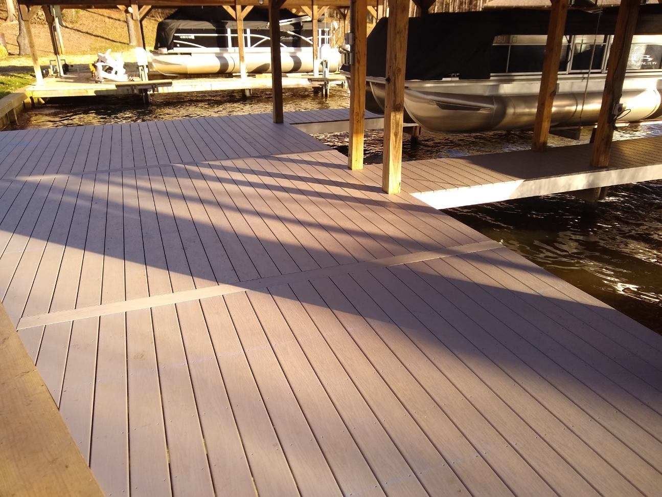 A boat is docked under a covered dock