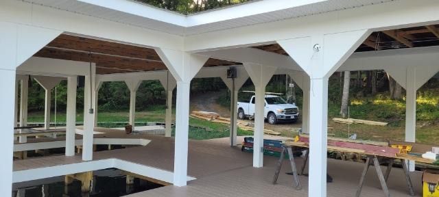 A white truck is parked in front of a building under construction.