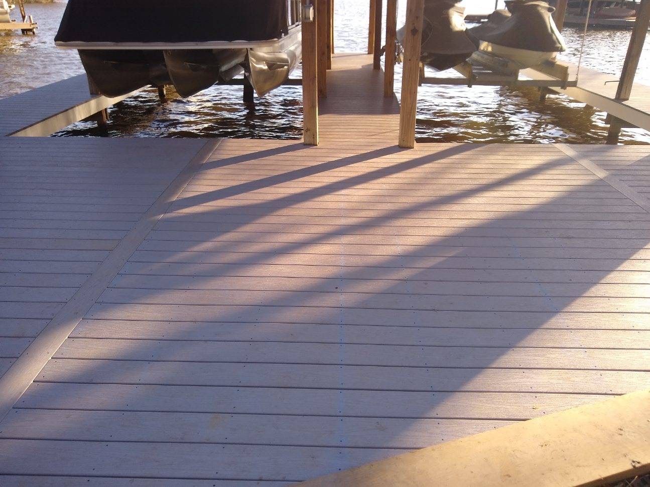 A white truck is parked in front of a building under construction.