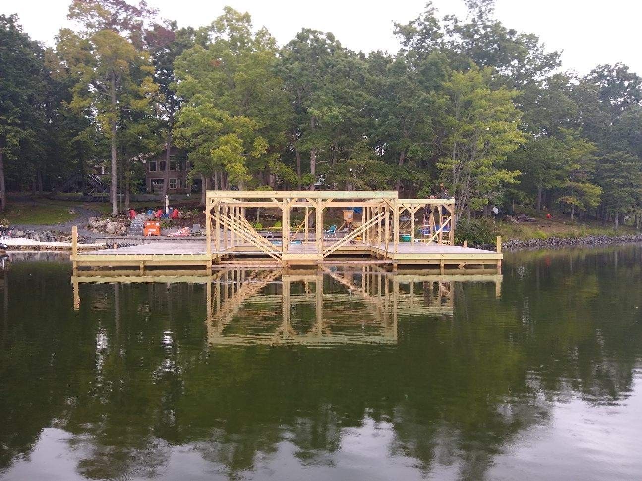 A wooden dock is being built in the middle of a lake.