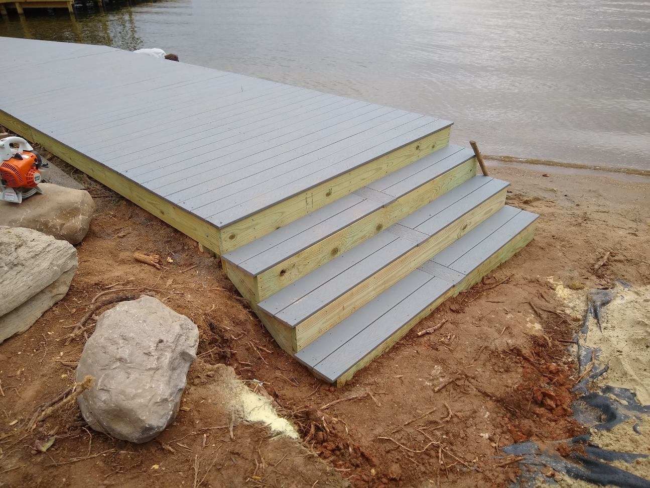 A wooden dock with steps leading to the water