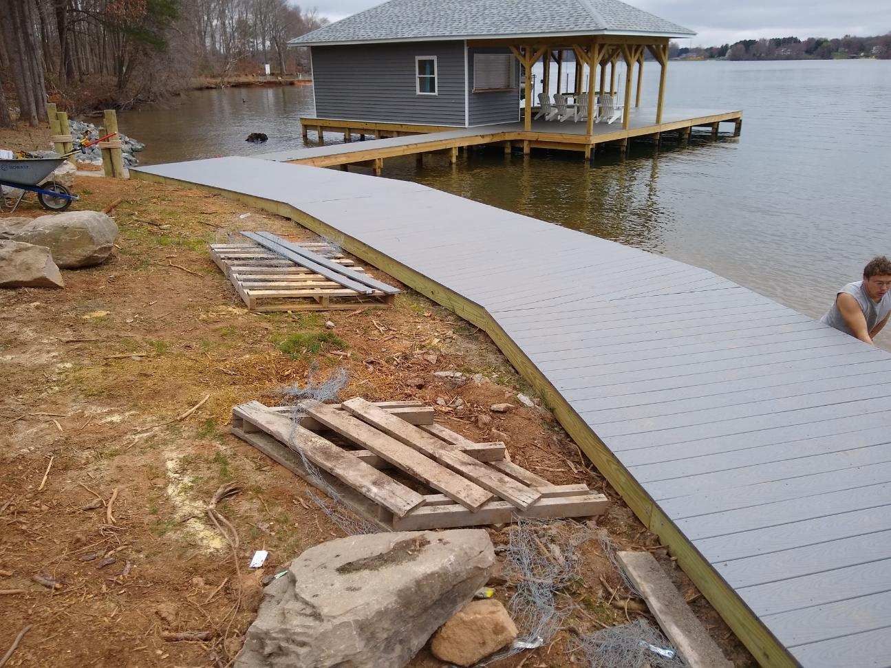 A dock is being built next to a house on a lake