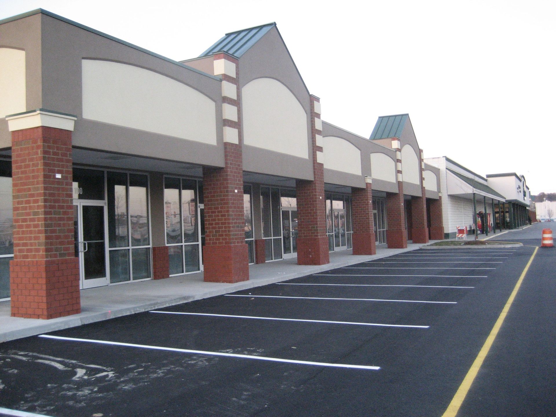A parking lot in front of a brick building