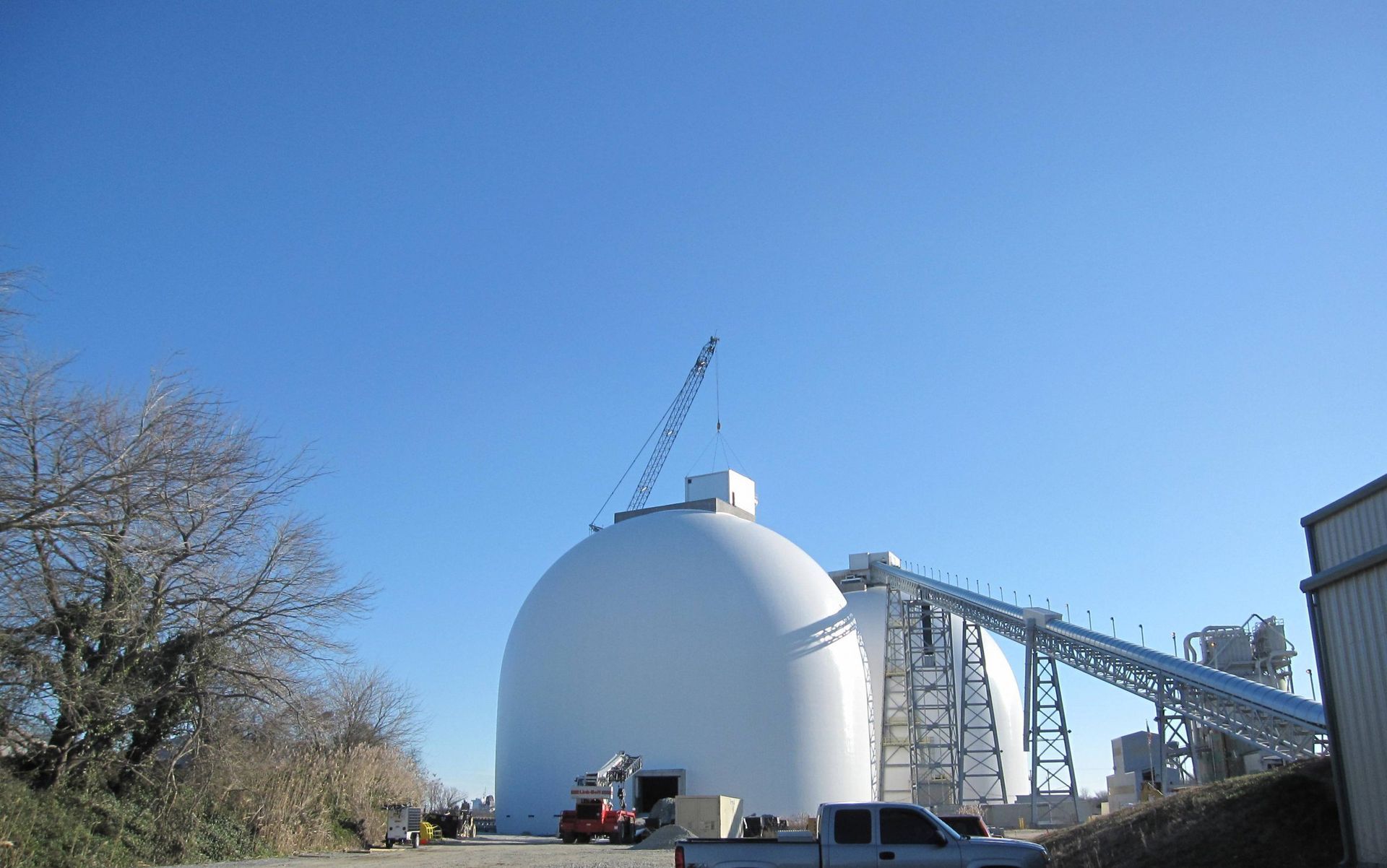 A large white dome with a crane on top of it