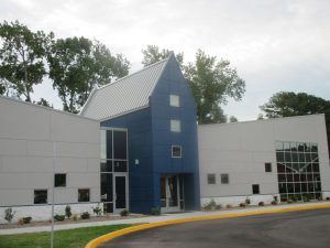 A blue and white building with a yellow curb in front of it
