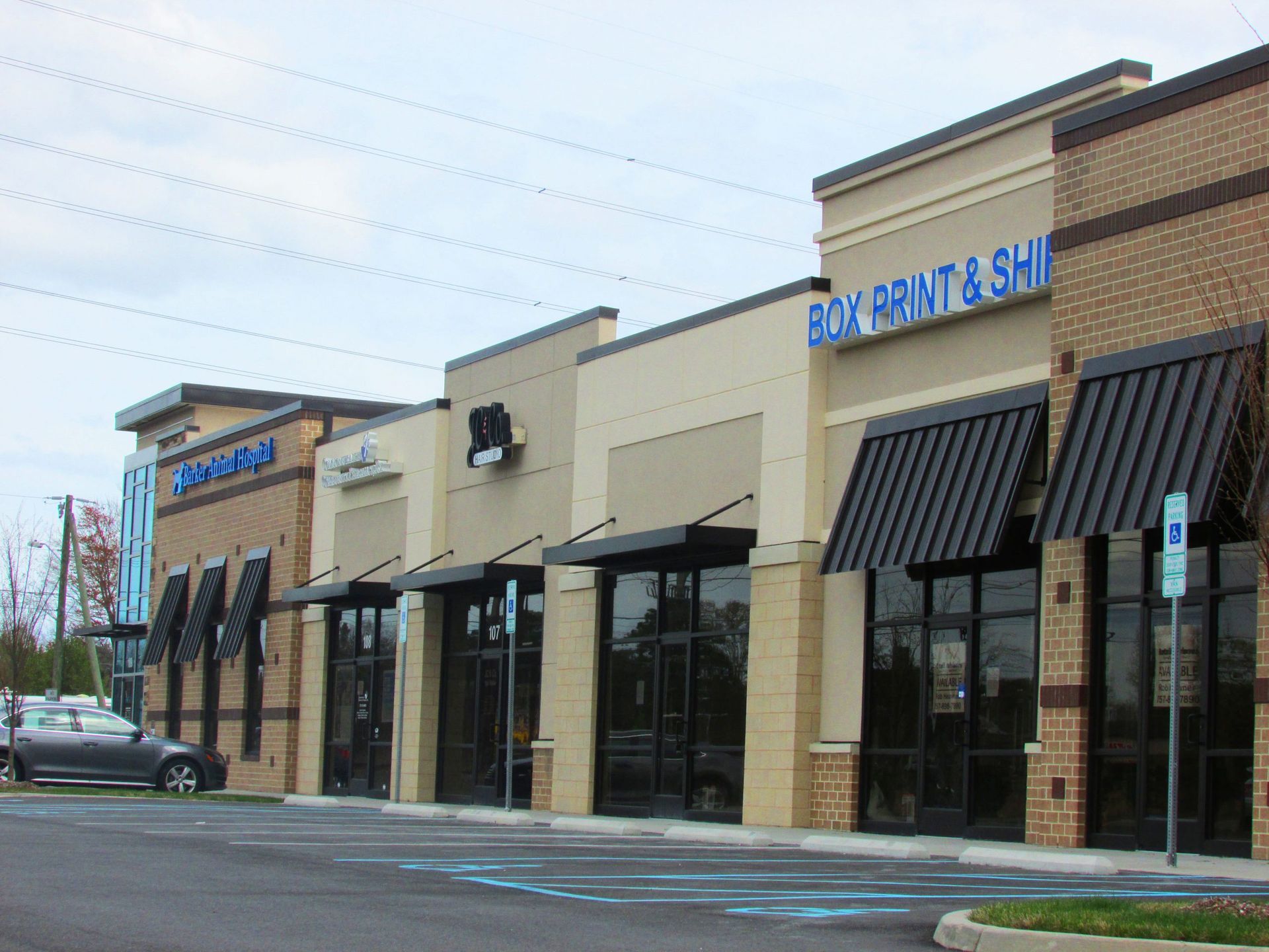 A building with a sign that says box print & ship