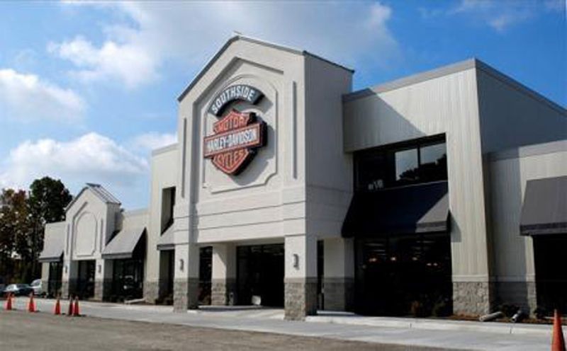A harley davidson store with a sign on the front