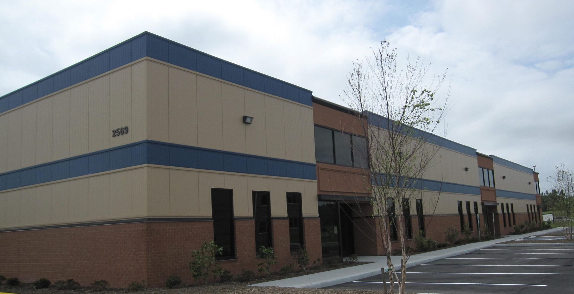 A large building with a blue and tan stripe on the side