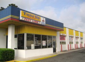 A blue and yellow building with a sign that says tune up fast lube