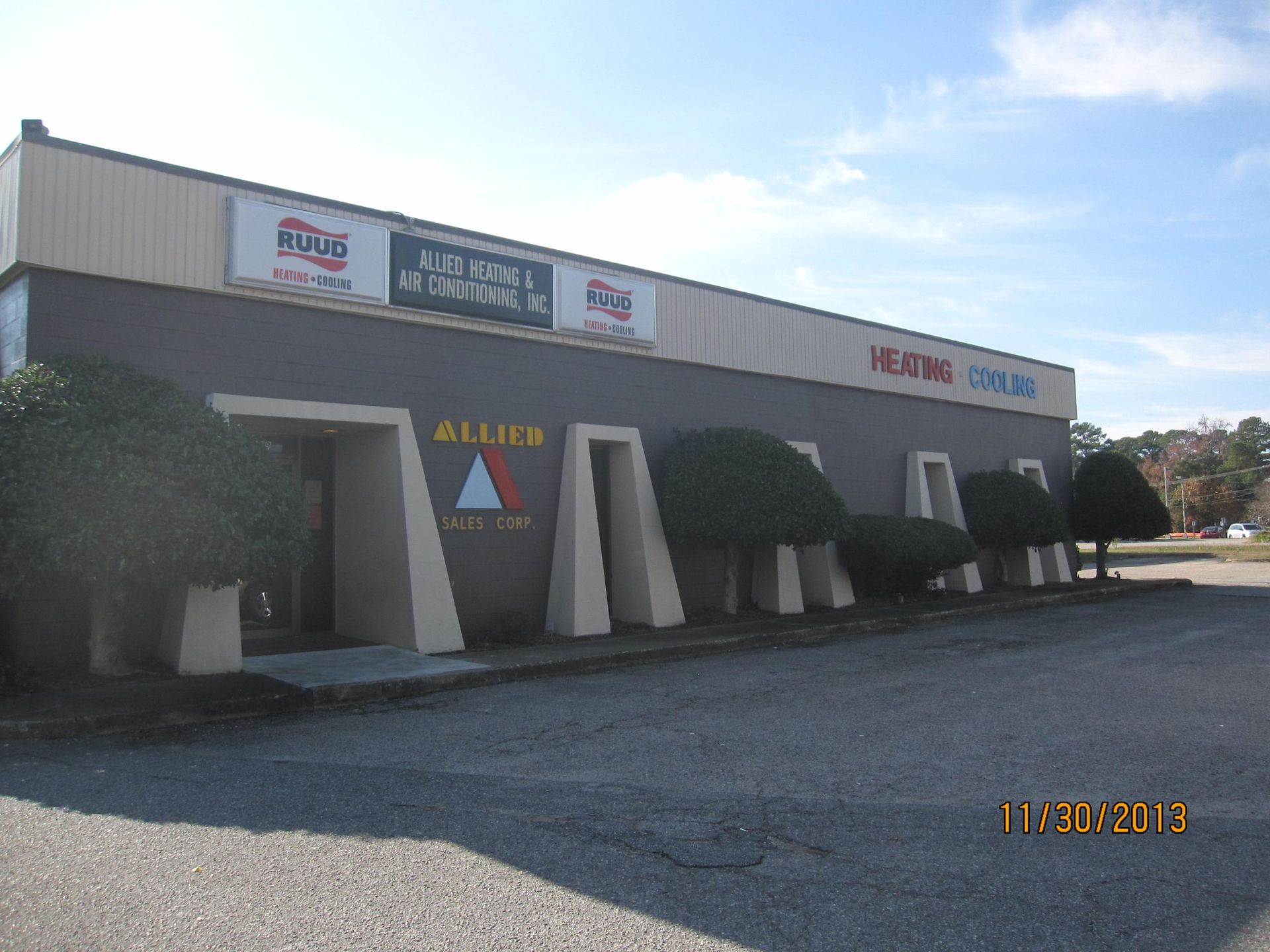 A building with a sign on the side that says allan