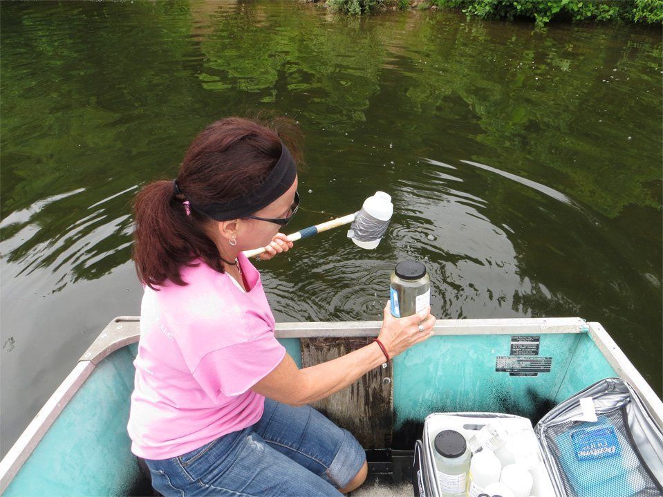 A woman in a pink shirt is sitting on a boat