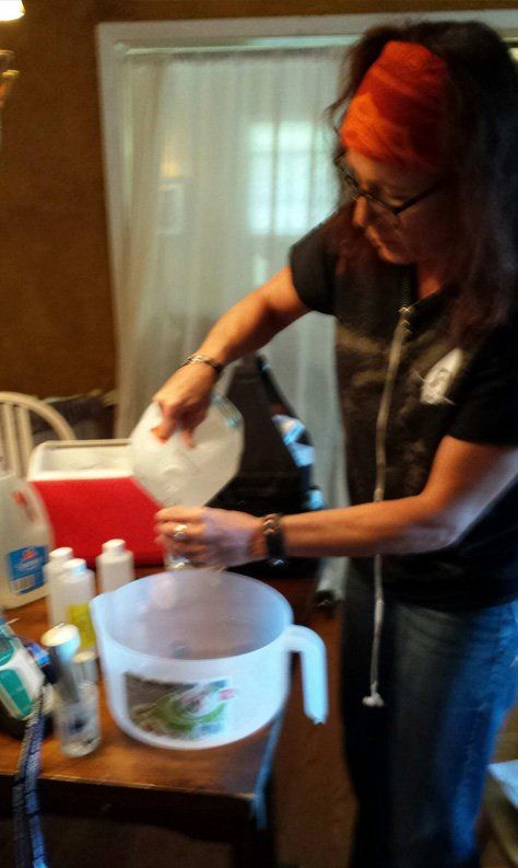 A woman is pouring water into a measuring cup.