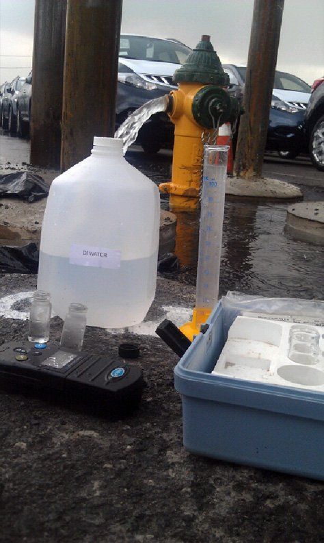 A gallon of water is sitting next to a fire hydrant.