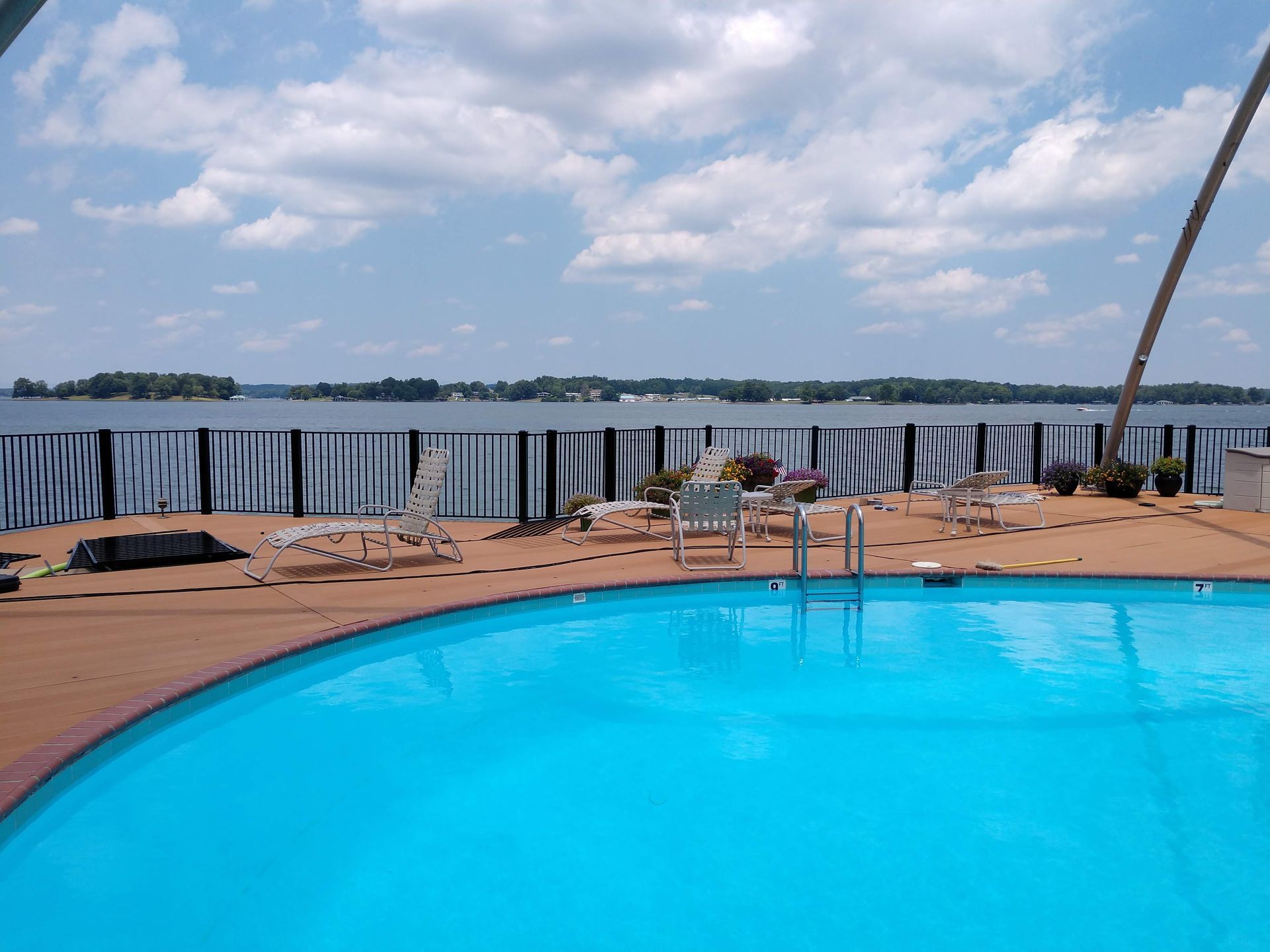 A large swimming pool with a view of a body of water