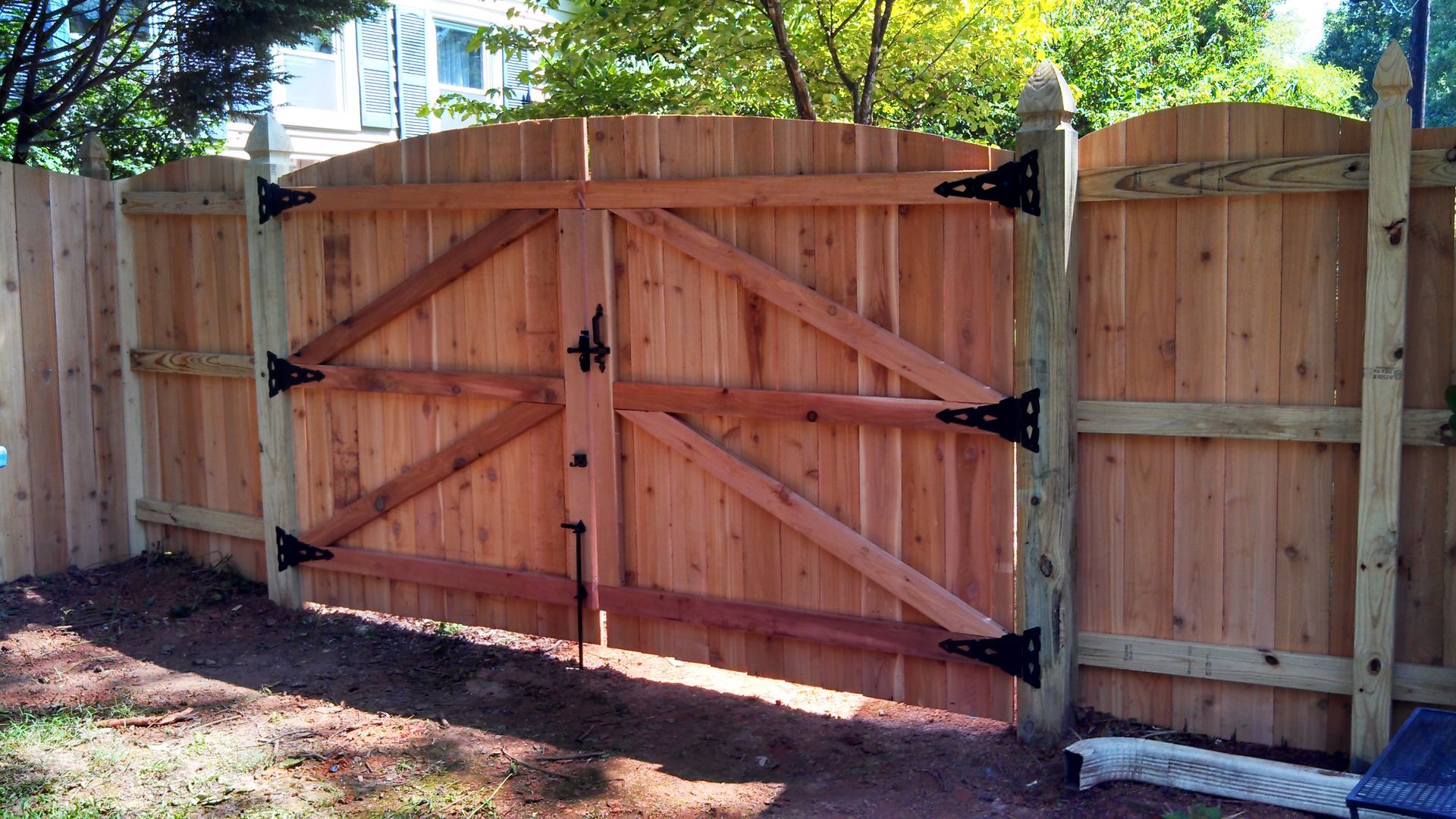 a wooden fence with a gate attached to it