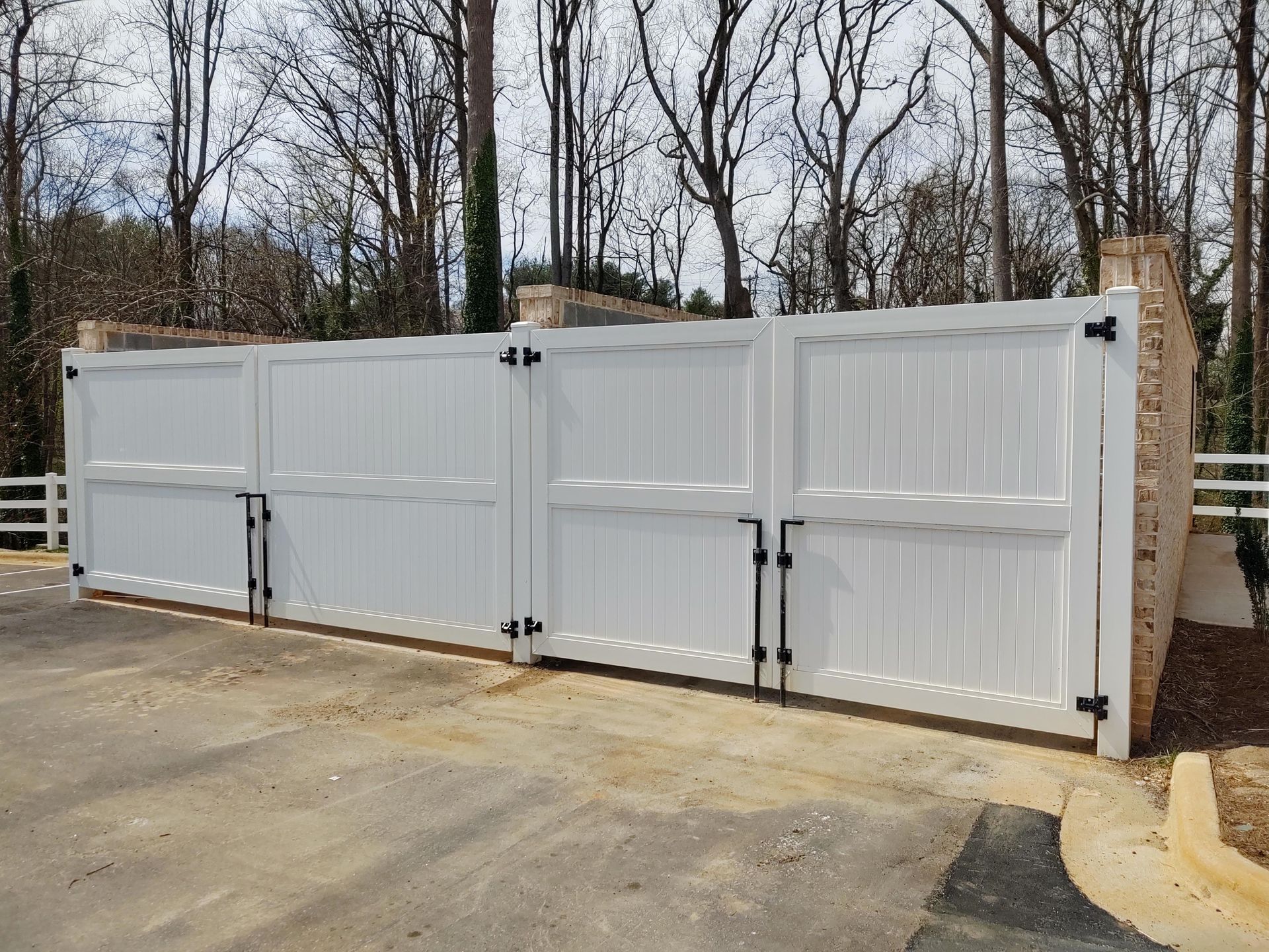 a white gate sitting in the middle of a parking lot