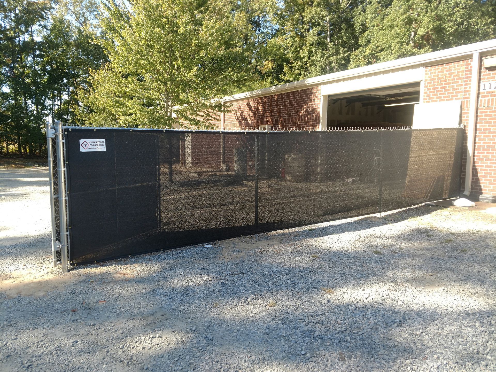 a black fence sitting in front of a brick building