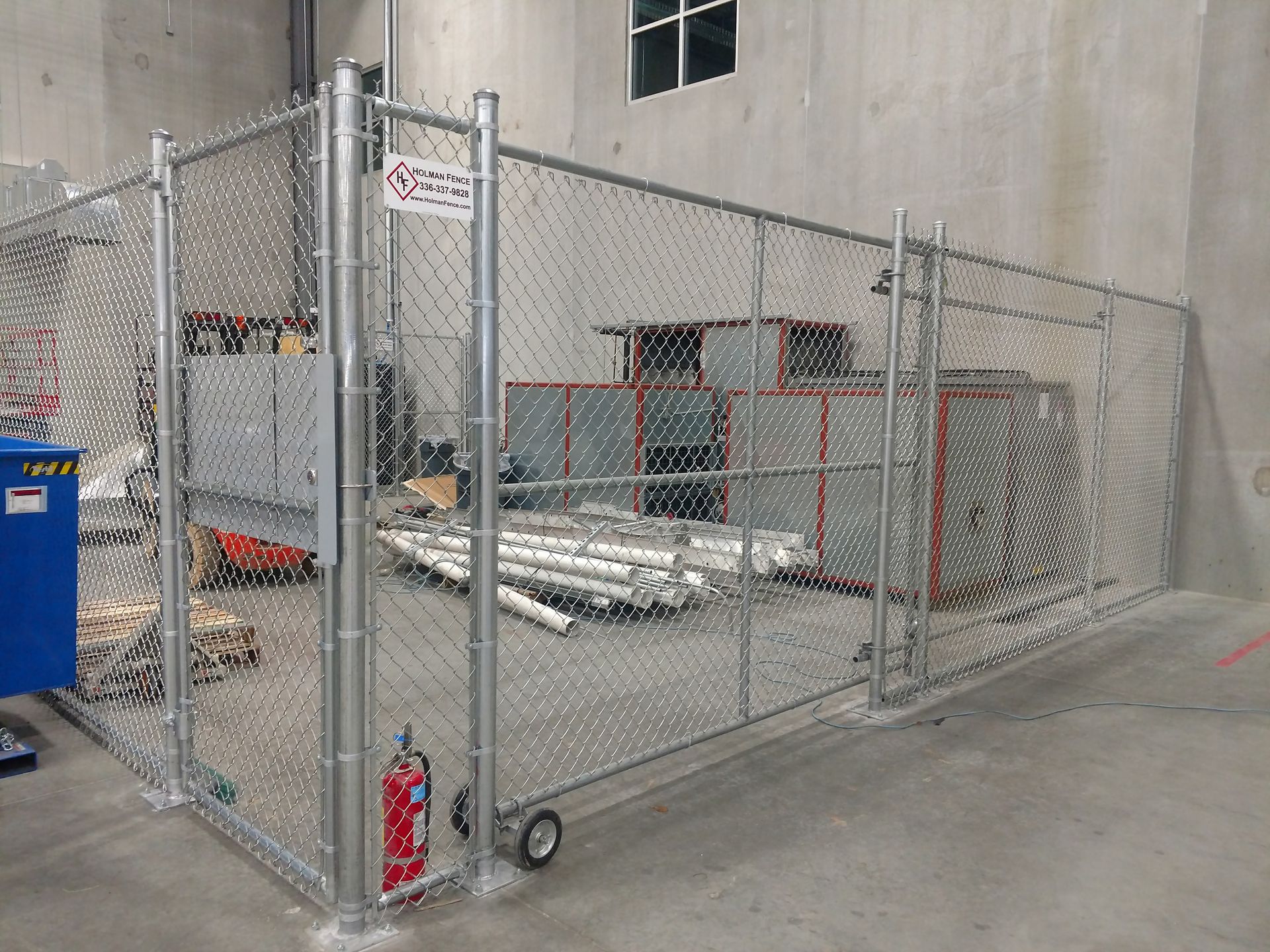 a chain link fence surrounding a building in a warehouse