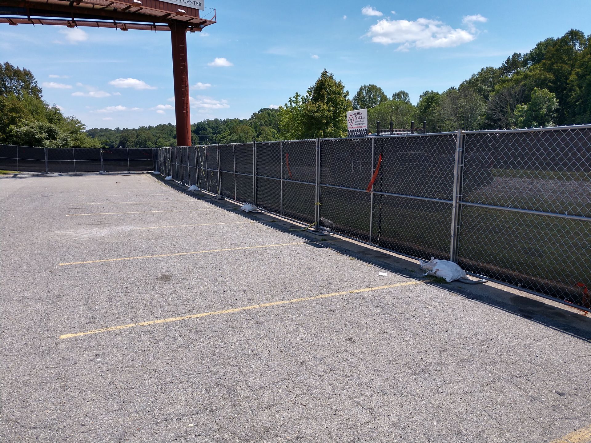 a parking lot with a chain link fence surrounding it