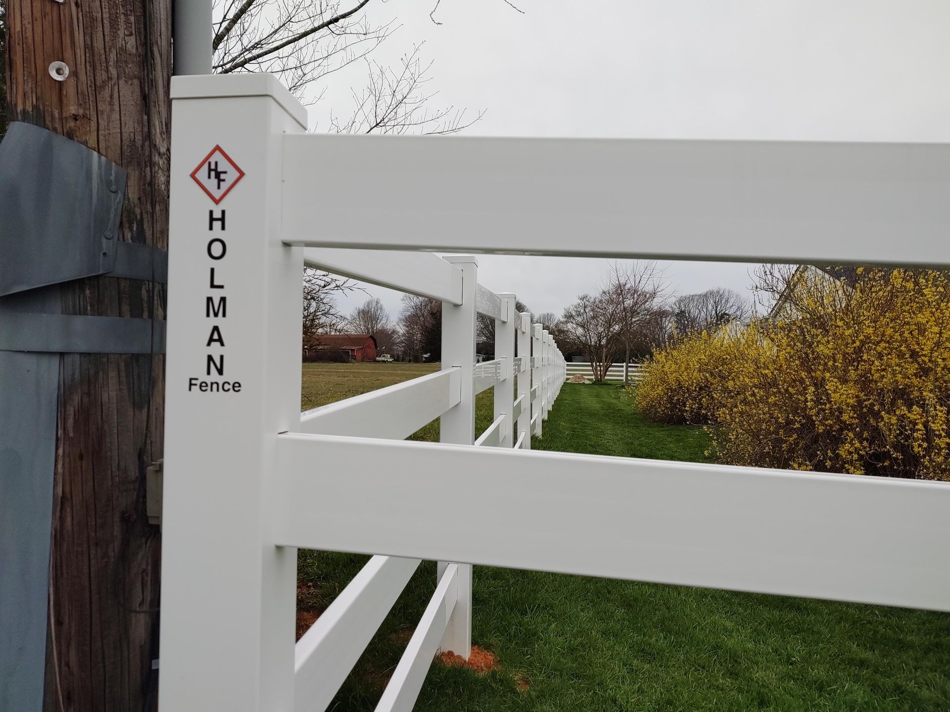 a white fence with the word Holman written on it