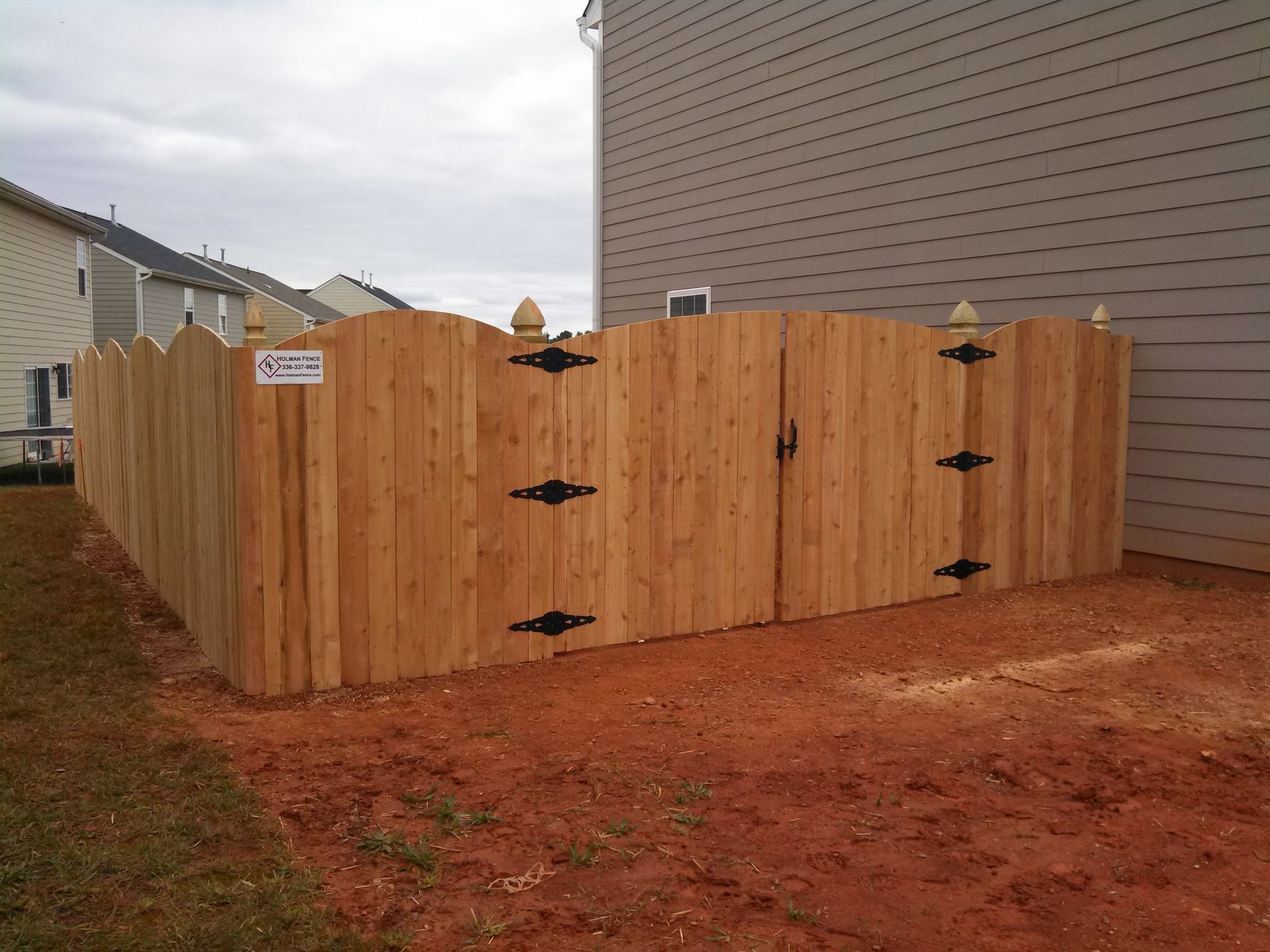 a wooden fence with a sign on it that says
