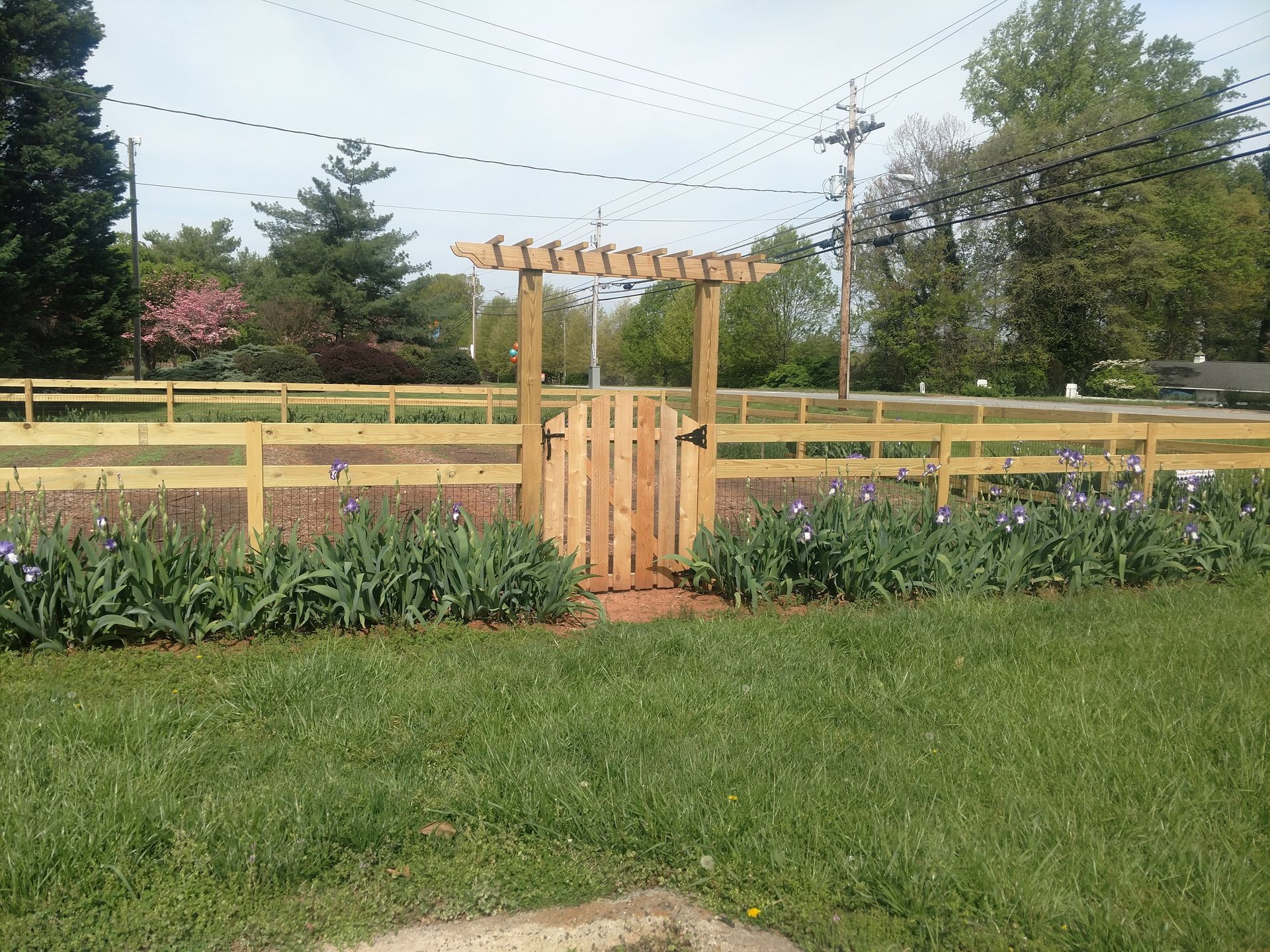 a wooden fence with a gate in the middle of it