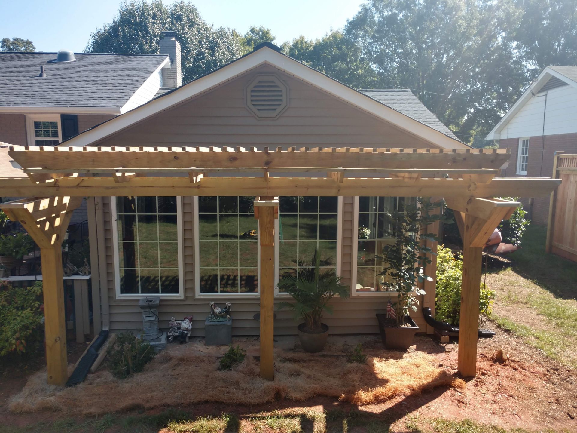 a house with a pergola in front of it