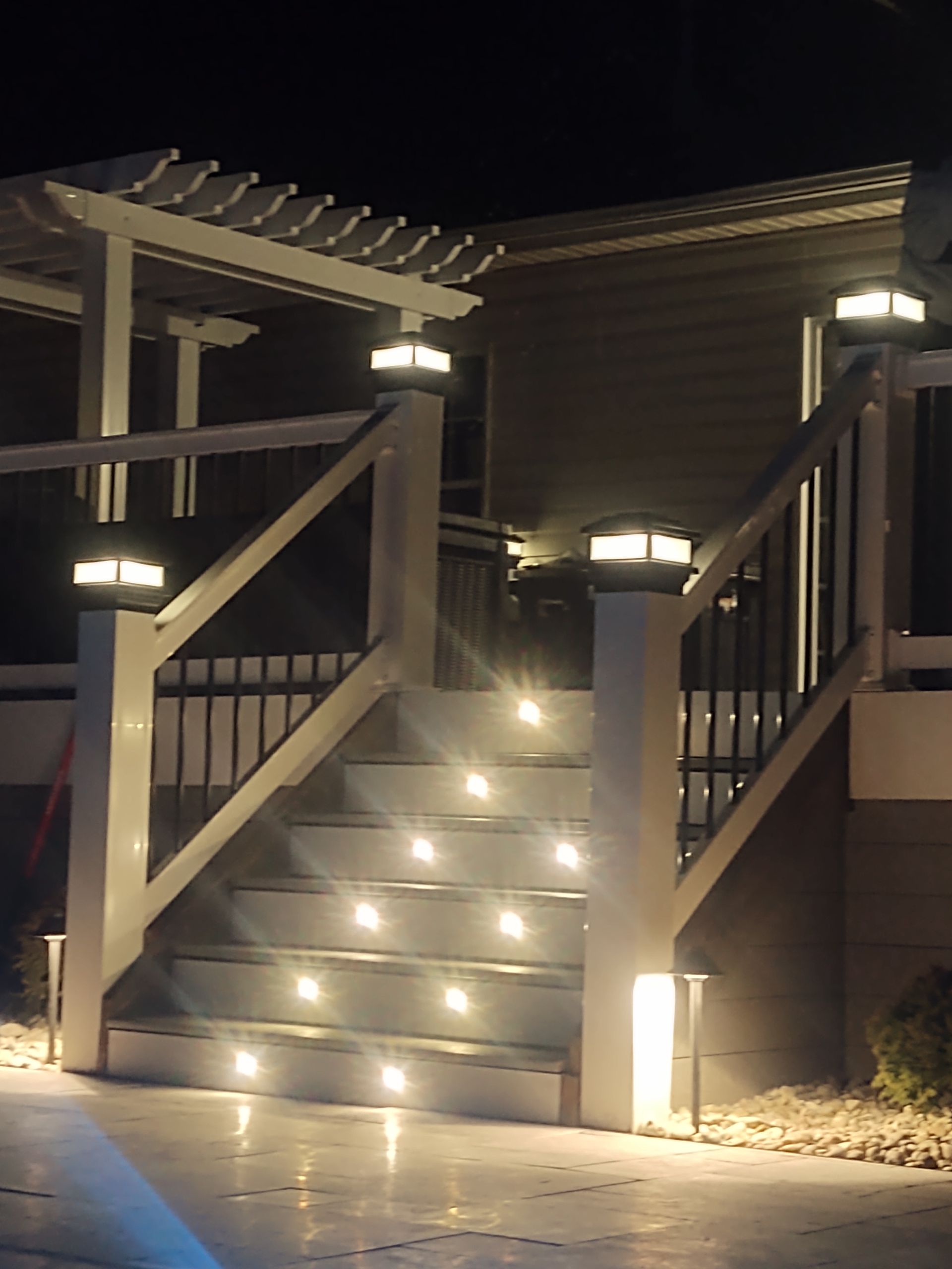 A house with stairs that are lit up at night