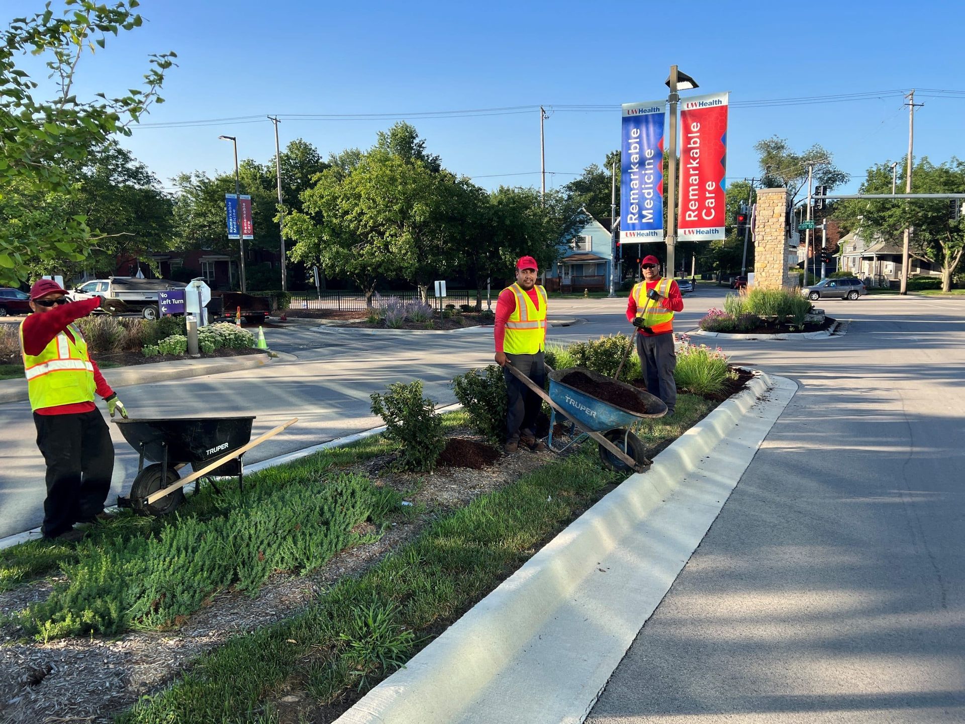 Stone retaining wall next to water. Grass on top. Boat visible in background.